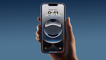 A person holding an Apple iPhone 16e displaying a circular abstract lock screen image.