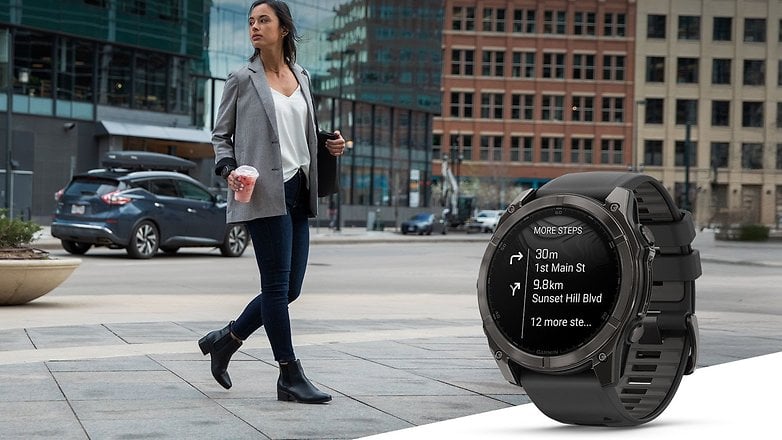 A woman walking in a city wearing a blazer, holding a drink, with a Garmin watch displaying directions. A woman walking in a city wearing a blazer, holding a drink, with a Garmin watch displaying directions.