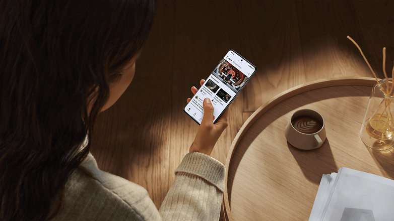 A person holding the OnePlus 12 and browsing the internet