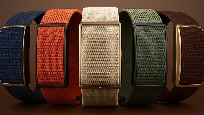 Five colorful Polar Loop fitness bands in blue, orange, white, green, and brown against a brown background. Five colorful Polar Loop fitness bands in blue, orange, white, green, and brown against a brown background.