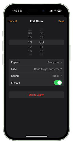 A smartphone alarm setting screen with the label 'Don't forget sunscreen!' for daily reminders.