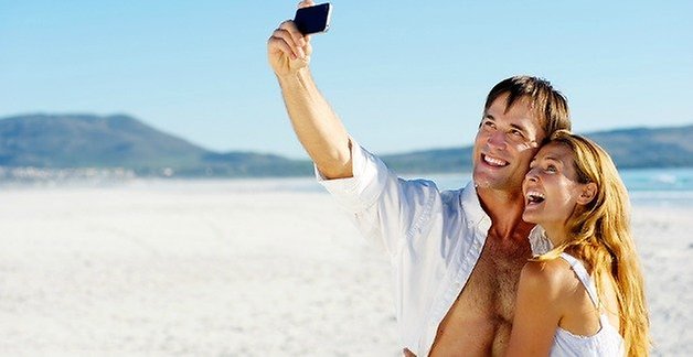 couple with a smartphone on the beach