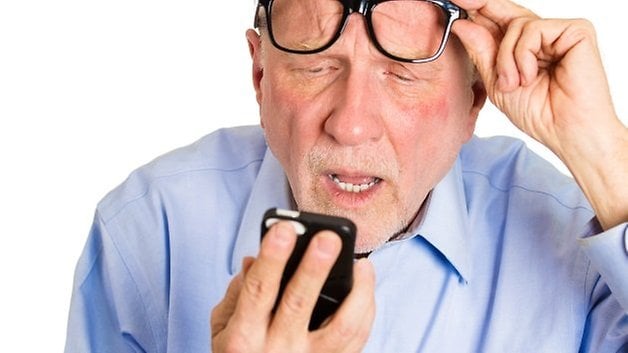 old man looking at smartphone