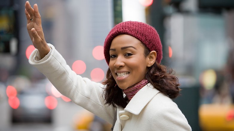 a pretty young business woman hails a taxi cab in the city graphic stock