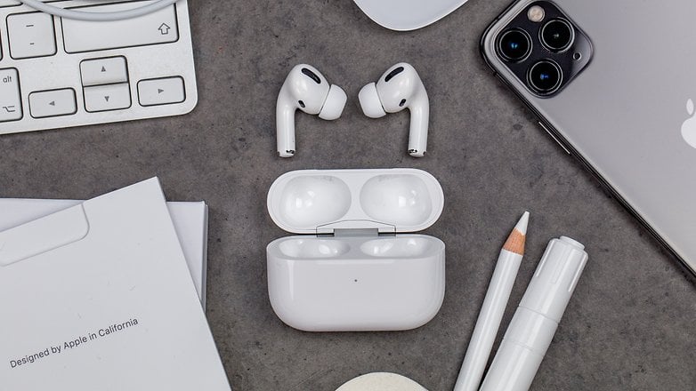 Apple Airpods Pro case open sounded by Apple products like iPhone, Magic keyboard, Apple Pencil, and the AirPods Pro.