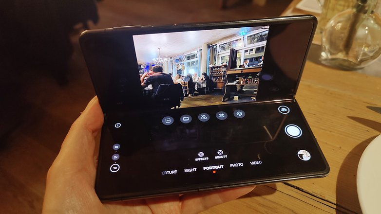 Huawei Mate X3 partially opened showing a split interface for the camera app
