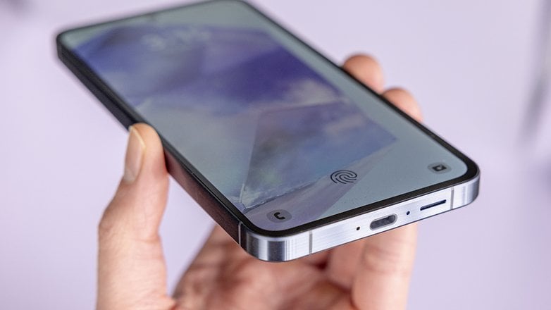 Galaxy A55 held in hand showing the USB-C charging port