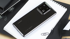 The Xiaomi 13 Pro laid diagonally flat on a white notebook with its black color on the back