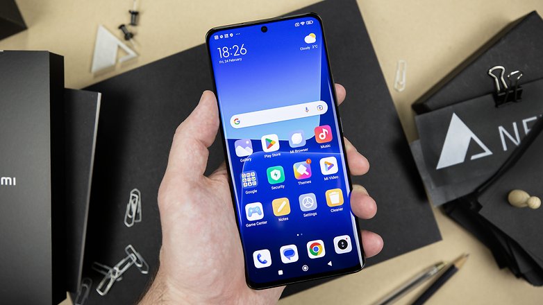 The Xiaomi 13 Pro held in a left hand and seen from the front with its AMOLED screen