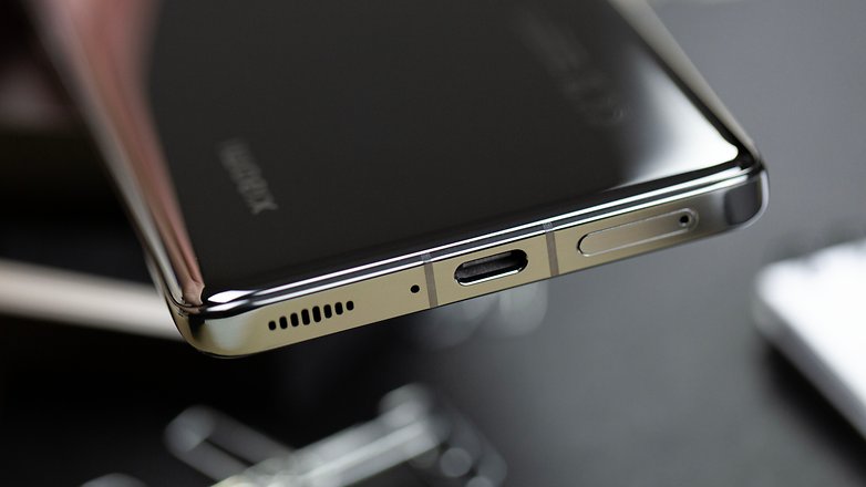 The Xiaomi 13 Pro seen in a low-angle view with its USB-C port and metallic aluminum frame