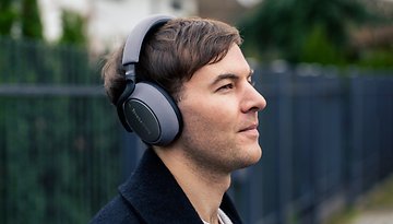 A person wearing a headphone in the street