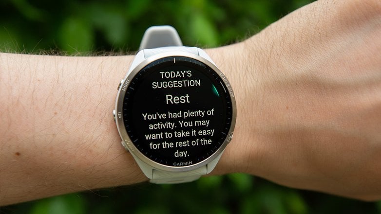 A Garmin Forerunner 965 watch displaying a suggestion to rest after a day of activity.