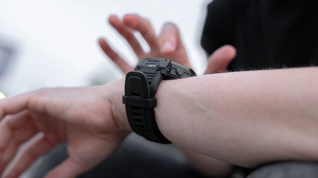A close-up of a person's wrist wearing an Amazfit T-Rex Pro 3 smartwatch.