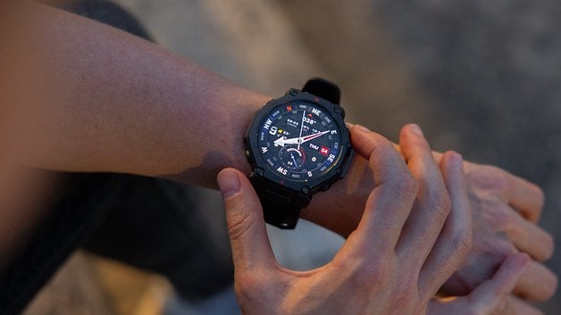 A person adjusts an Amazfit T-Rex Pro 3 smartwatch on their wrist.