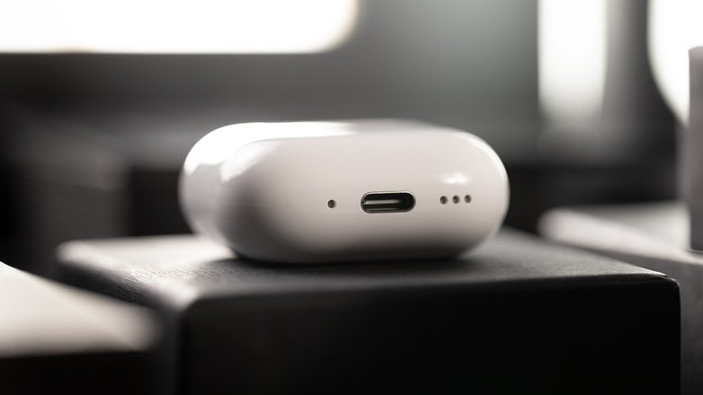 Close-up of a white Apple AirPods charging case with a USB-C port.