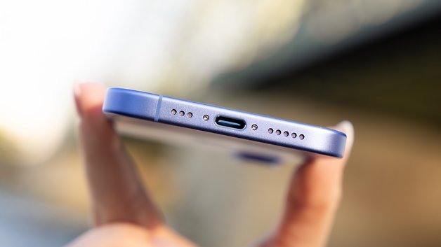 Close-up of an iPhone 16 showing the bottom with a USB-C port and speaker holes.