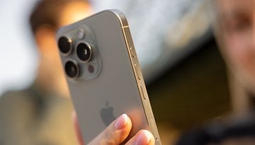 Gros plan d'un iPhone 16 Pro tenu à la main, mettant en valeur sa caméra et ses boutons.