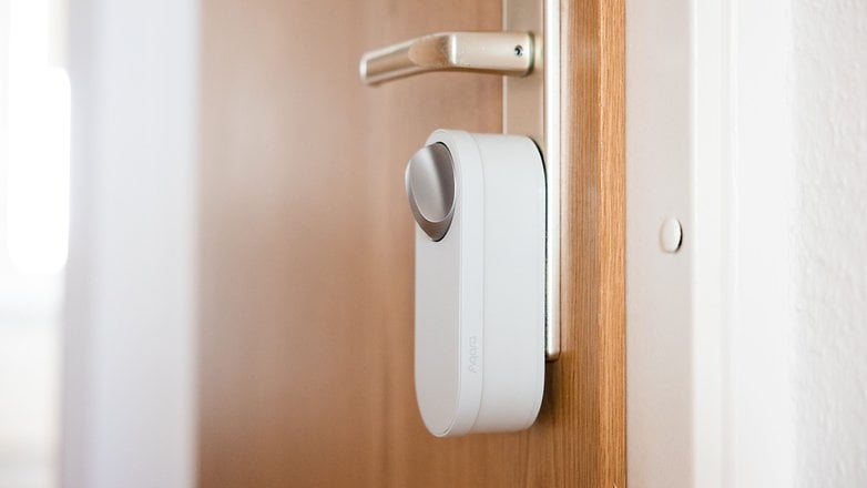 Aqara U200 Lite smart door lock mounted on a wooden door.