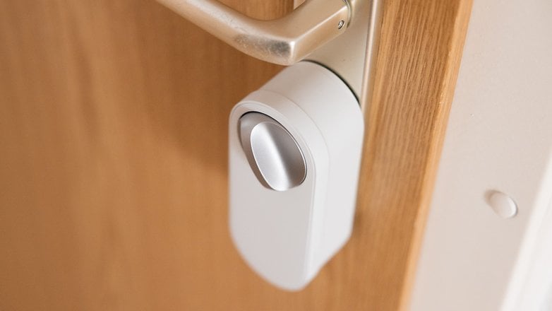 A close-up of the Aqara U200 Lite smart door lock mounted on a wooden door.