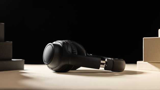 The Audio-Technica ATH-S300BT headphones seen from the side and placed on a table.