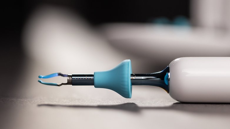 Close-up of a bebird home ear cleaning tool with a blue tip and silver metal shaft.