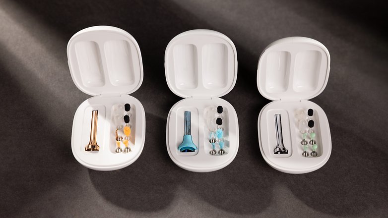 Three white cases containing various ear cleaning tools and attachments.