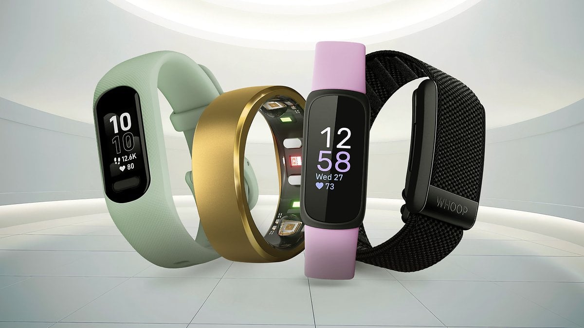 Three fitness trackers in various colors displaying heart rates and steps.