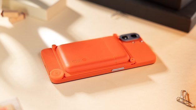 The CMF Phone 1 laid flat and seen from behind on a table, with its card case accessory attached.