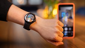 A person using the Pixel Watch to remote control the Pixel 8 Pro camera