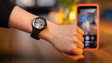A person using the Pixel Watch to remote control the Pixel 8 Pro camera