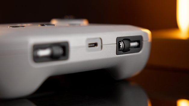 Close-up of a gray device with ports and buttons, probably a controller.