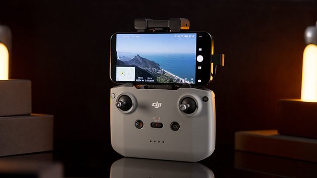 DJI Neo drone control with a smartphone that displays an aerial photo and flight data.