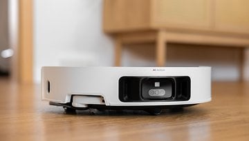 A Dreame X50 Ultra robotic vacuum cleaner on a wooden floor.