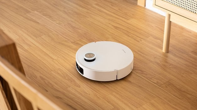 Dreame X50‌ Ultra robot cleaner navigating around‍ furniture.