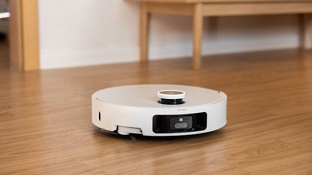 Dreame X50 Ultra robot vacuum ‍cleaner positioned on wooden flooring.