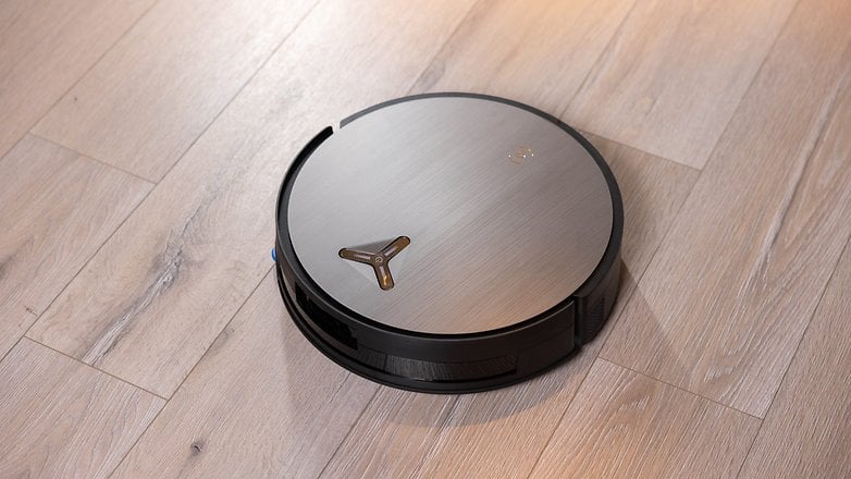 Ein eleganter Ecovacs Deebot X11 Omnicyclone Roboterstaubsauger auf Holzfußboden. Ein eleganter Ecovacs Deebot X11 Omnicyclone Roboterstaubsauger auf Holzfußboden.