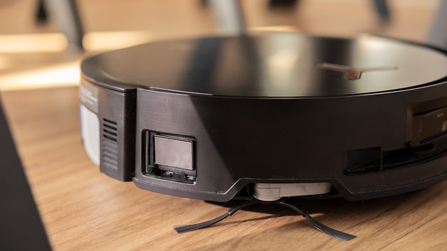 Close-up of the Ecovacs Deebot X8 Pro Omni robot vacuum cleaner on a wooden floor.