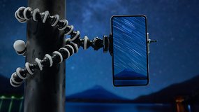 A phone mounted on a tripod, taking pictures of the stars.
