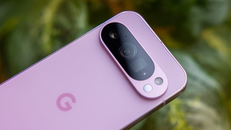 Close-up of a Google Pixel 9 Pro smartphone in a soft pink color, highlighting the camera module.