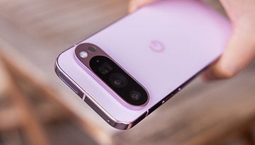 A close-up of a Google Pixel 9 Pro smartphone in a soft pink color, showing its camera module.