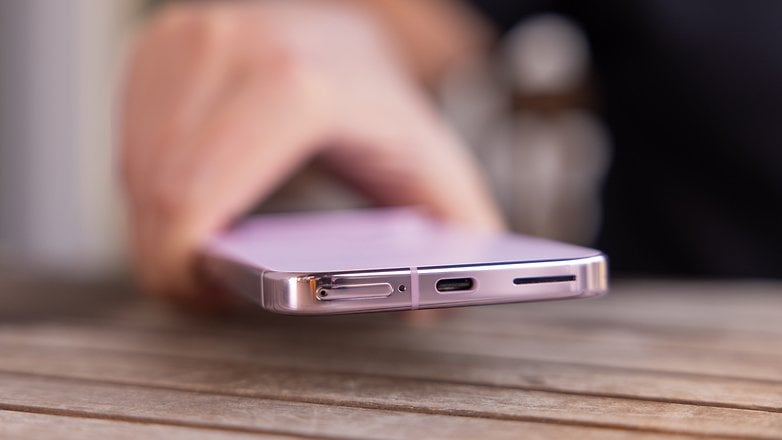 A close-up of a Google Pixel 9 Pro smartphone showing the SIM card slot and USB-C port.