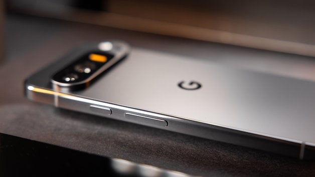 The Google Pixel 9 Pro XL seen from the side and laid face down, revealing its flat metallic edges.