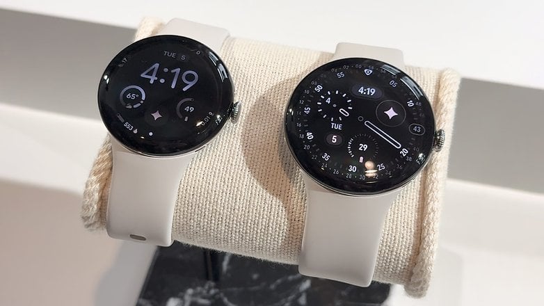 Zwei Google Pixel Watch 4 auf einem Display, die die Uhrzeit 4:19 und verschiedene Fitnessmetriken anzeigen.