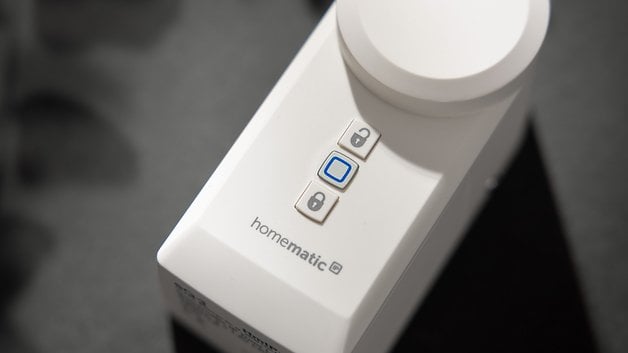 Gros plan sur une serrure intelligente Homematic IP avec trois boutons, dont un bleu.