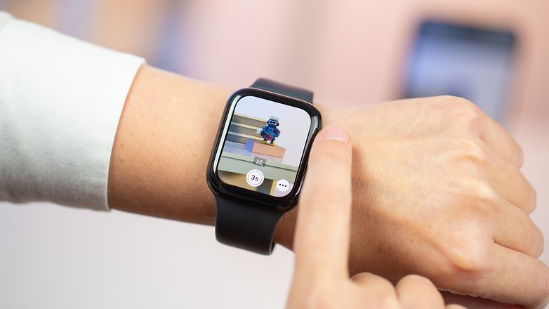 A person using the digital crown of the Apple Watch to zoom in the iPhone camera
