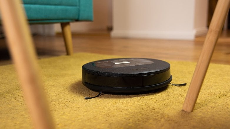 Lefant F1 robot vacuum cleaner cleaning a carpet in a living room.