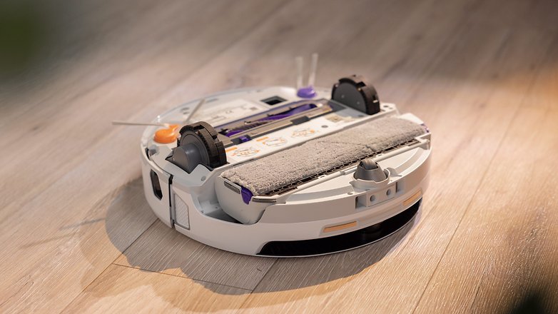 A robotic vacuum cleaner on a wooden floor, designed for efficient cleaning. A robotic vacuum cleaner on a wooden floor, designed for efficient cleaning.