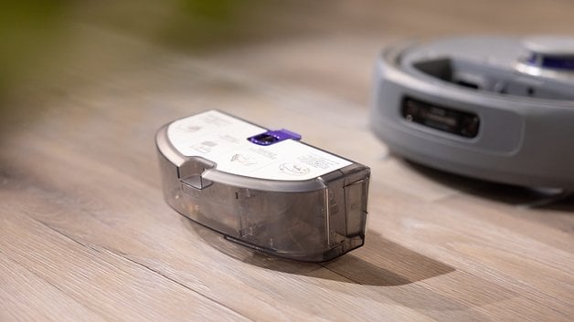 The dust container of the Narwal Z10 Ultra robot vacuum cleaner lies on a wooden floor.