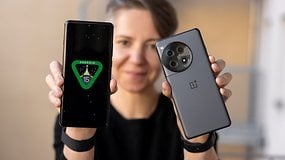 A person holds two OnePlus smartphones, one displaying 'ANDROID 15' on the screen.