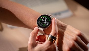 A person checking the OnePlus Watch 3 on their wrist, displaying time and fitness stats.
